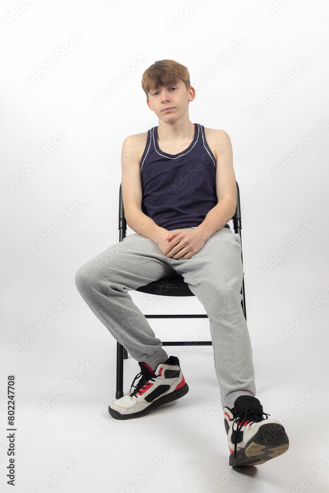 A Teenage Boy Sitting in A Chair A Teenage Boy Sitting in A Chair