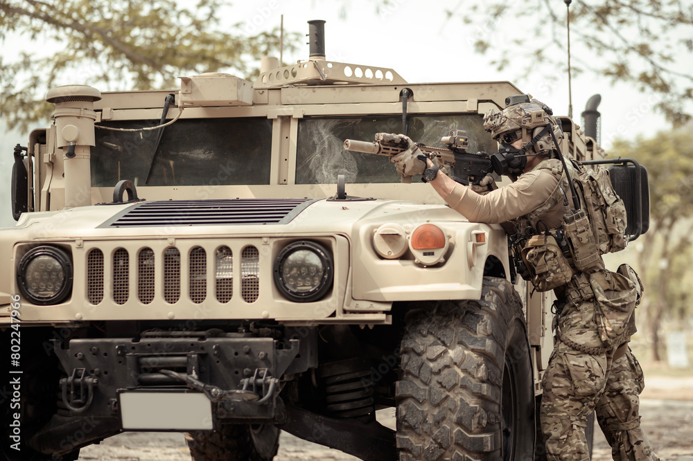 United States Army in camouflage uniforms operation in the forest.with armored vehicle, soldiers training in a military operation United States Army in camouflage uniforms operation in the forest.with armored vehicle, soldiers training in a military operation