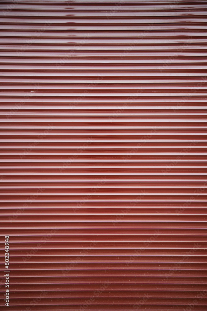 Metalic commercial roll up door texture . vertical shot , copy space