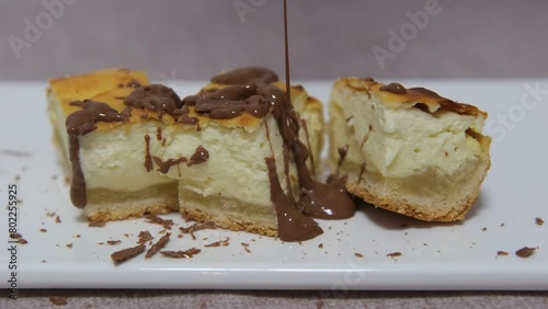 Cheesecake. Two layers of puff pastry filled with whipped cream. pour chocolate over it, slow motion. Tasty and healthy photo