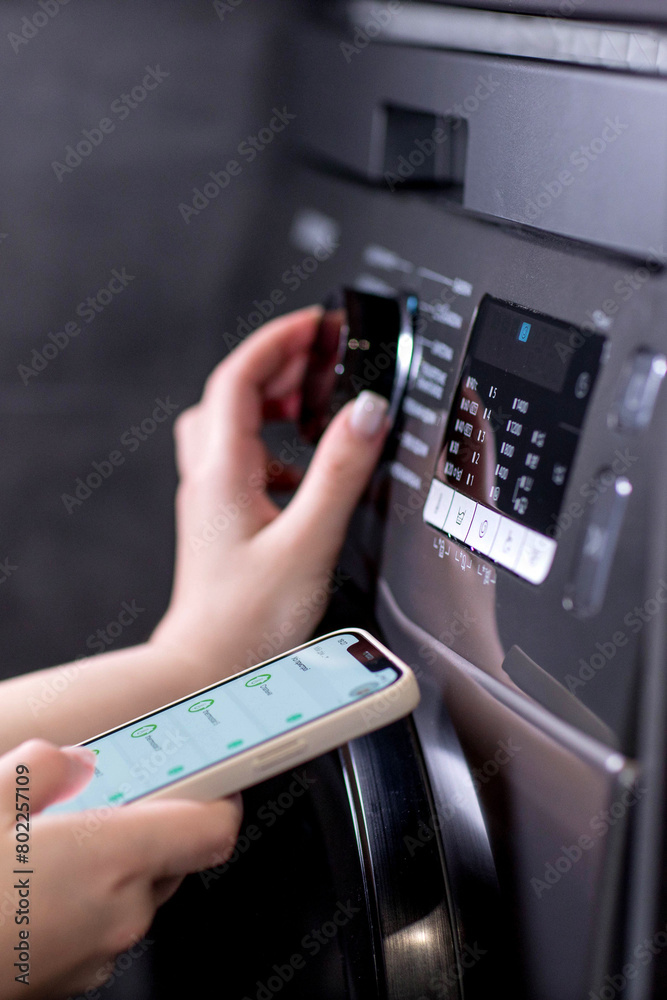 Smartphone with app used to control washing machines Smartphone with app used to control washing machines