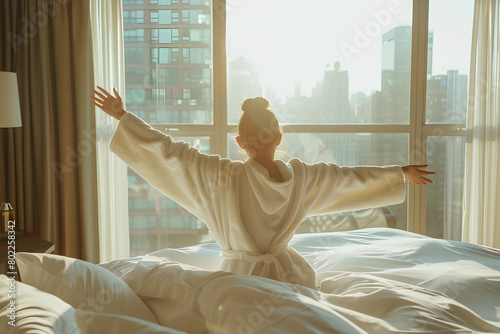 Wallpaper Mural Woman stretching hands in bed after wake up, sun flare . Brunette entering a day happy and relaxed after good night sleep and back view. Concept of a new day and joyful weekend Torontodigital.ca