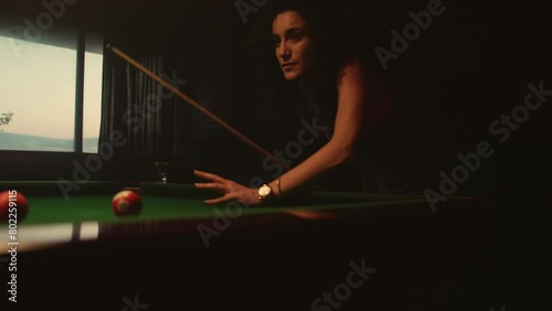 Woman playing pool in bar