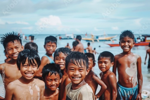 group of asian children playing in the sea on the beach. photo