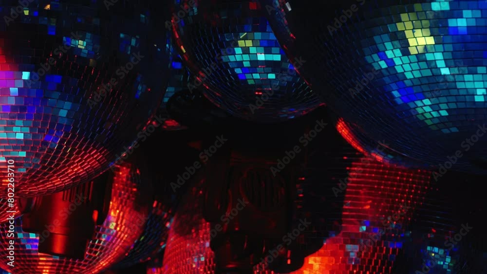 A close up of a disco ball with a blue and purple background. Part of series Disco Balls Illuminated.
