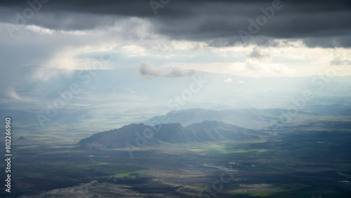 Armenian highlands landscape with mountains  green fields and thick clouds  Mount Ararat in Turkey