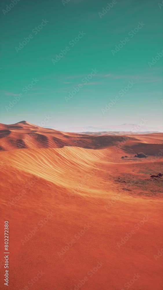 A vibrant red desert landscape stretches under a clear blue sky, showcasing a striking contrast between the earthy tones and the bright, open sky. A vibrant red desert landscape stretches under a clear blue sky, showcasing a striking contrast between the earthy tones and the bright, open sky.