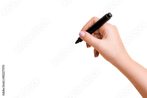 Female hand holding a black marker and about to write on a blank background
