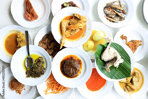 Nasi Padang, various Minang Side Dish on the Table photo