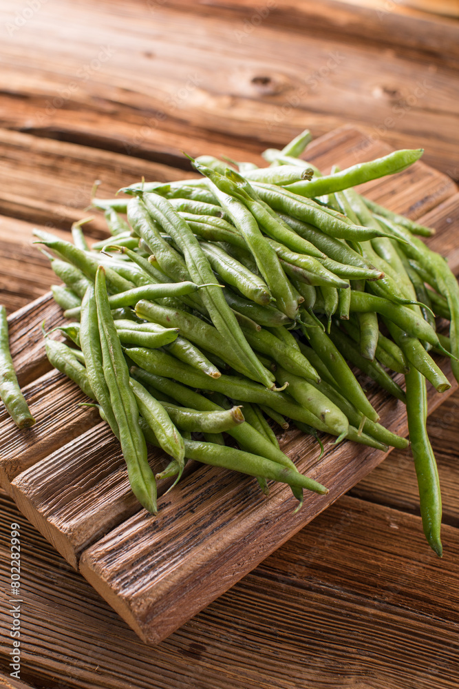Fresh young beans pods. Old wooden background. Green string beans crop conception Fresh young beans pods. Old wooden background. Green string beans crop conception