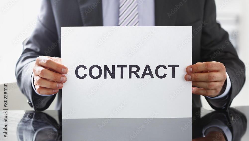 Man in suit and tie hold in arms contract closeup. Bid or tender job decision terms and conditions human resources candidate legal law client financial plan concept Man in suit and tie hold in arms contract closeup. Bid or tender job decision terms and conditions human resources candidate legal law client financial plan concept
