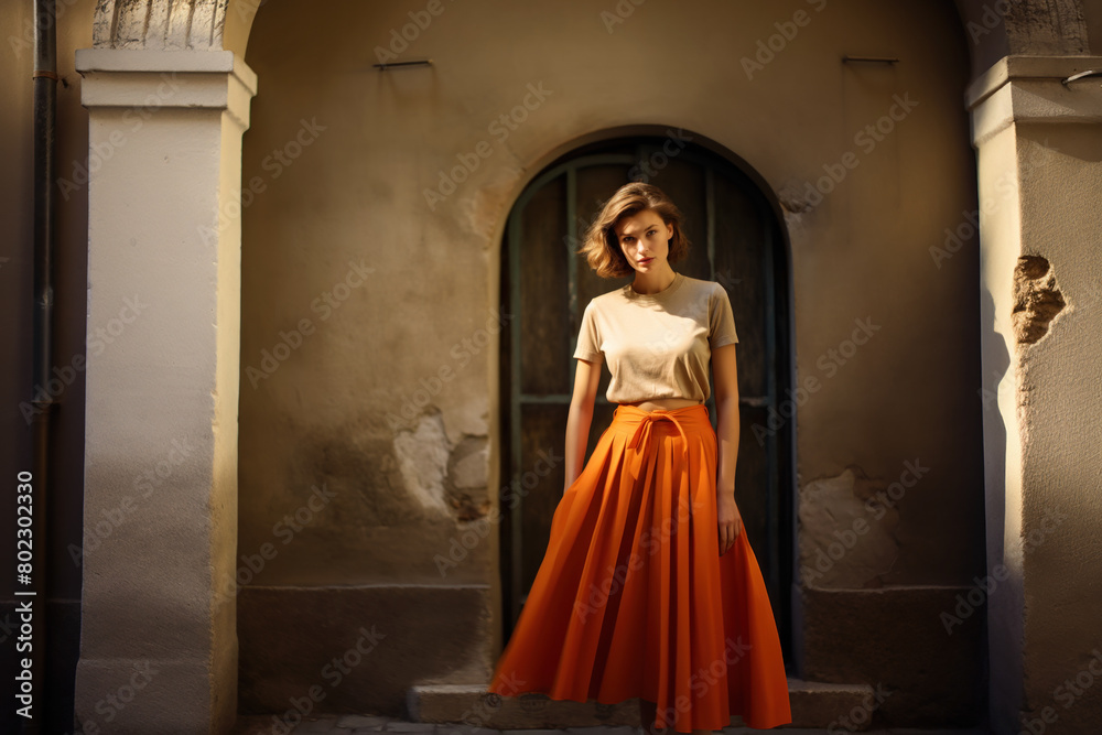 Beautiful woman wearing an orange pleated skirt.