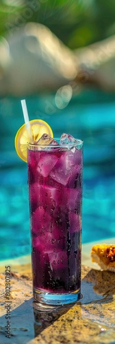 A glass of purple amande sparkling drink with ice cubes and lemon. photo
