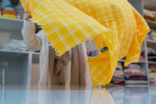 Close up view of waving yellow fabric with white lines. photo