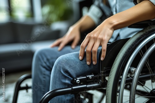 Person seated in wheelchair, hands on wheels