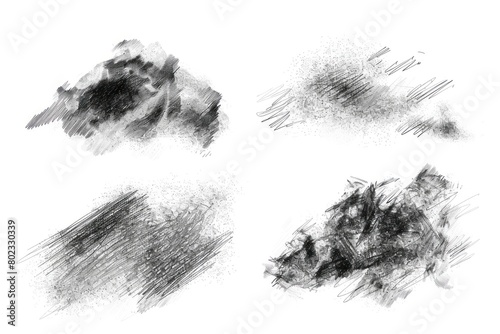 Close-up of different sets of charcoal scribble drawings isolated on white background.
