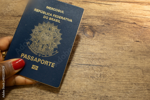 LAURO DE FREITAS, BRAZIL - April 26, 2024 : Brazilian passport on wooden table photo