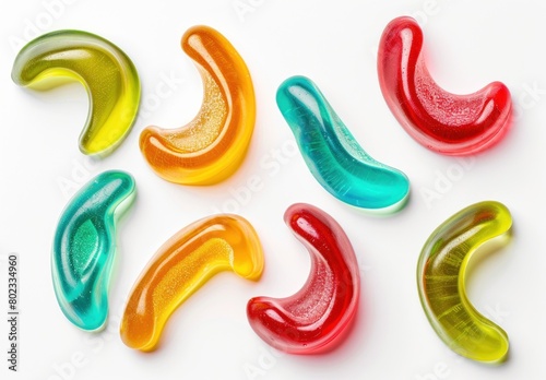 A selection of gummy candies in different shapes and flavors, set against a pristine white background 