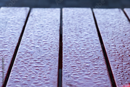 A wooden table with a wet surface