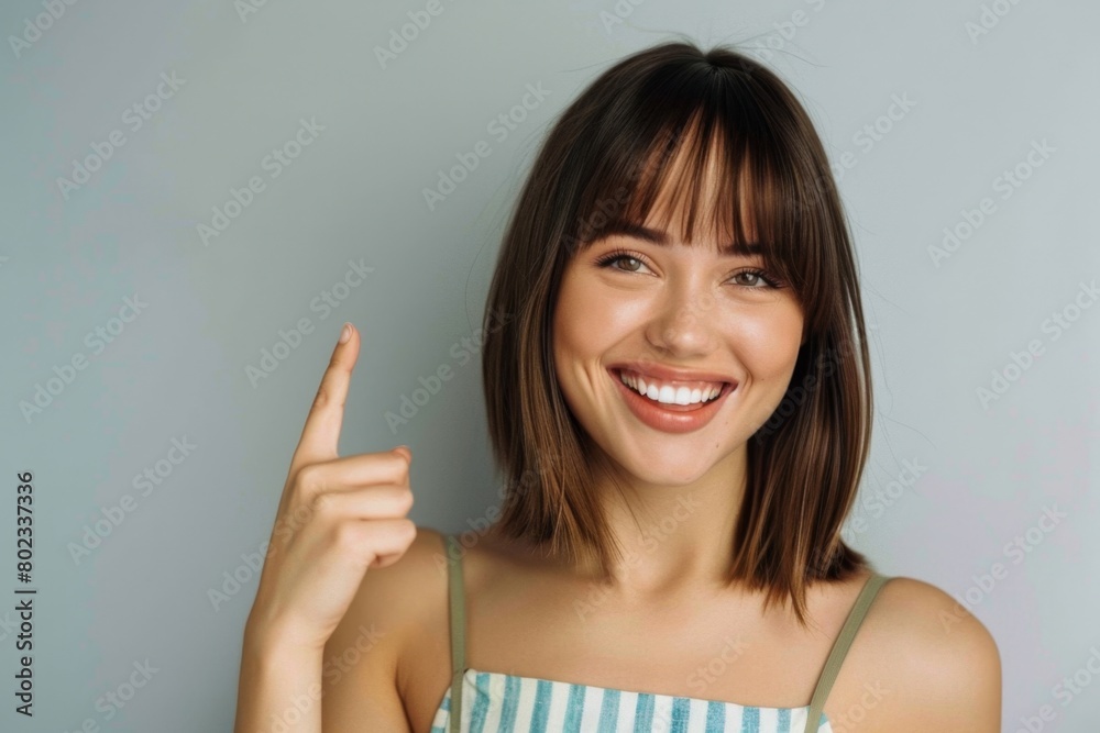 A beautiful woman is smiling and pointing at the top right corner of her photo A beautiful woman is smiling and pointing at the top right corner of her photo