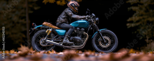 Motorcyclist riding on autumnal road photo