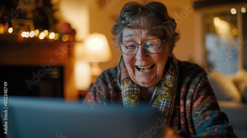 senior woman video chatting with her grandchildren on a laptop, her face filled with joy