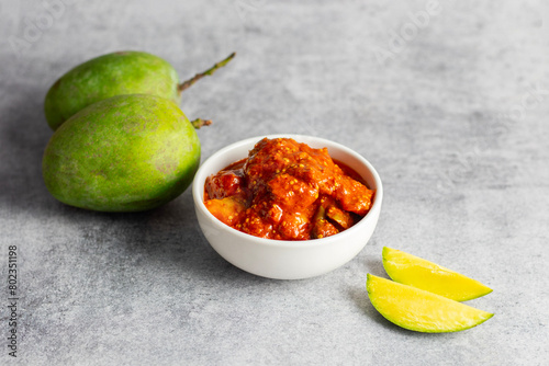 selective focus of Mango Pickle with green sliced mango.  photo