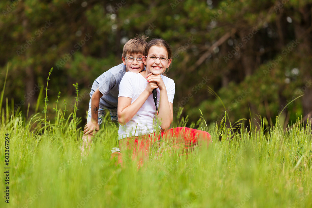 Fototapeta premium Boy and girl in a grass field