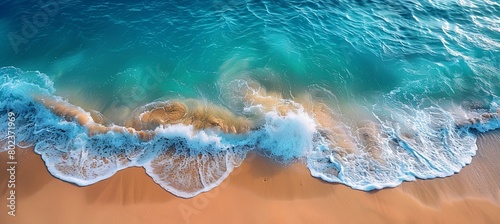 beach with clear blue water and waves gently lapping at golden sand
