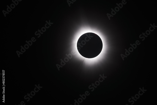 A black and white image of the total solar eclipse. Simple background image. Landscape
