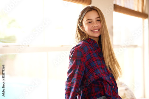 Portrait, preteen and girl in home, smile and break in weekend, relax and happiness for vacation in city. Living room, window and kid with joy for holiday, student and learner of school in New York