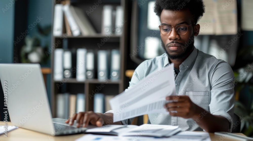 Man Analyzing Documents at Work