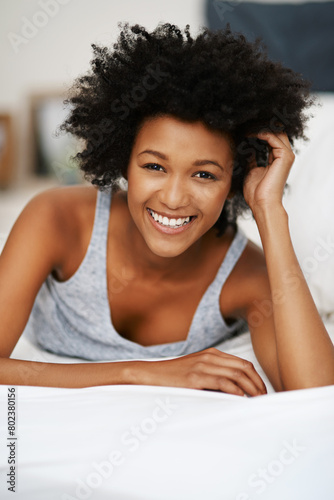 Black woman, smile and portrait in bed for relax, wellness and self care after sleep in house. Female person, happy and peace with duvet or pillow for wake up, health and stress therapy on weekend