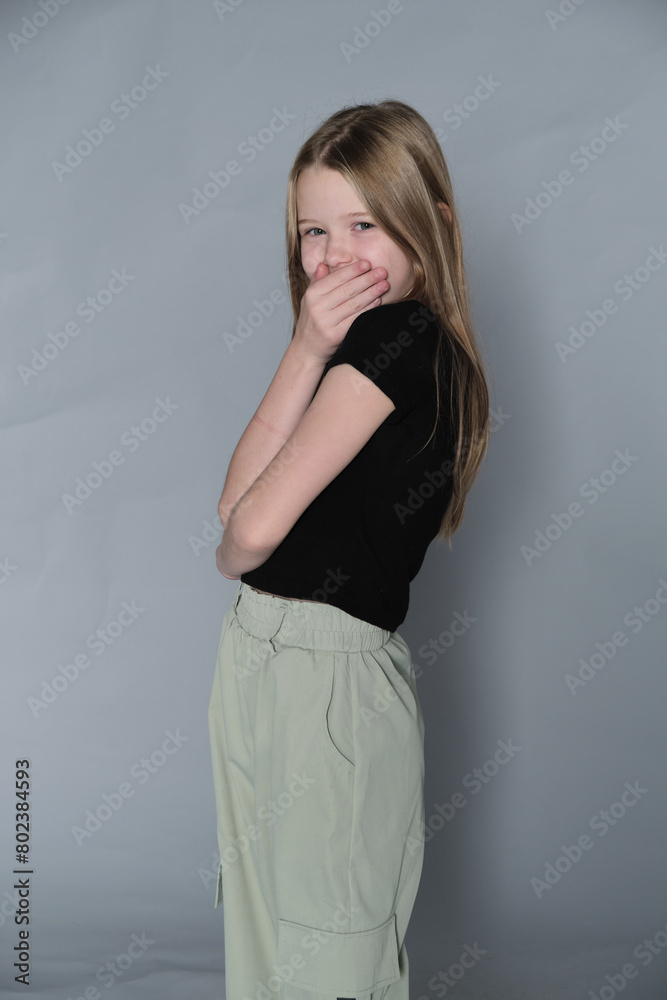 Girl in a moment of quiet contemplation, hands gently placed. Symbolizes the simplicity and sincerity of young thoughts. Girl in a moment of quiet contemplation, hands gently placed. Symbolizes the simplicity and sincerity of young thoughts.