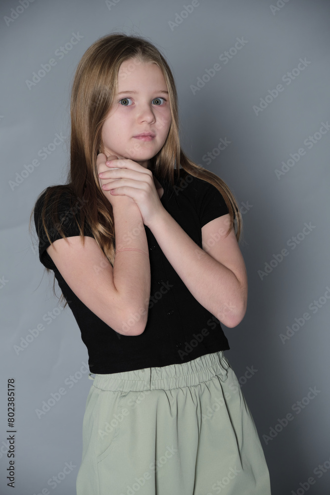 Thoughtful girl with hands clasped under chin, pondering. Captures the depth of a child's curiosity and reflection. Thoughtful girl with hands clasped under chin, pondering. Captures the depth of a child's curiosity and reflection.