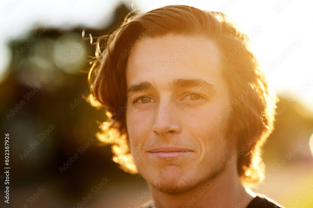 Portrait, man and smile with sunlight for adventure, positive and proud outdoors. Male person, confident and green eyes in nature for calm, relax and taking break in sunshine outside for wellness Portrait, man and smile with sunlight for adventure, positive and proud outdoors. Male person, confident and green eyes in nature for calm, relax and taking break in sunshine outside for wellness