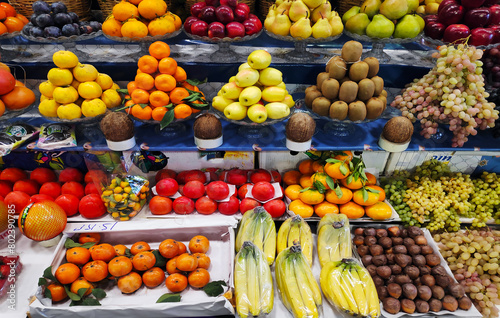 Apples, pears, pomegranates, bananas, oranges, grapes, kiwis, persimmons and other fruits on display at the market