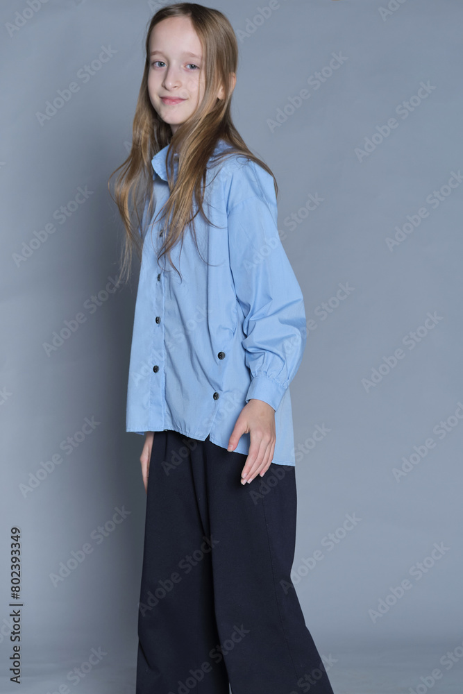 Bright-eyed girl showing poise in fashionable wear. Great for showcasing positive self-esteem in children's clothing lines. Bright-eyed girl showing poise in fashionable wear. Great for showcasing positive self-esteem in children's clothing lines.