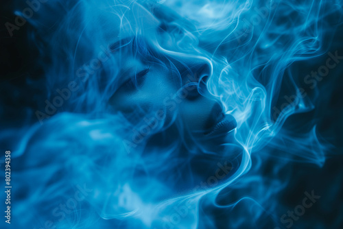 Swirls of blue and black smoke flow in a smooth dance against a dark background.