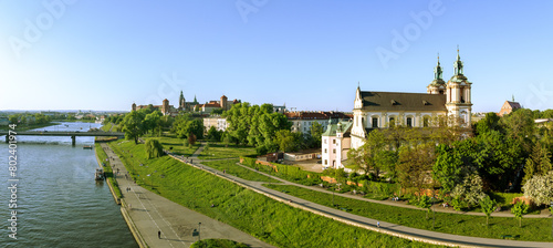 Krakow, Poland. Aerial panorama with Skalka church and Paulinite monastery, Vistula river, Wawel cathedral and castle in the background, bridge and boulevards along the riverside. Spring, sunset light
