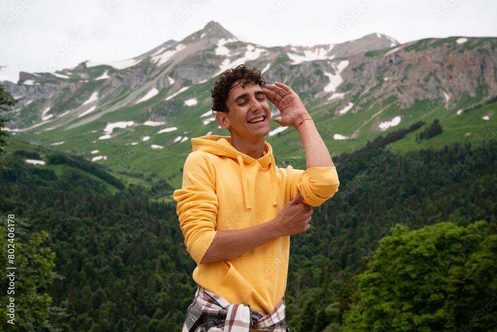 Naklejka premium A young attractive student is resting in the mountains.