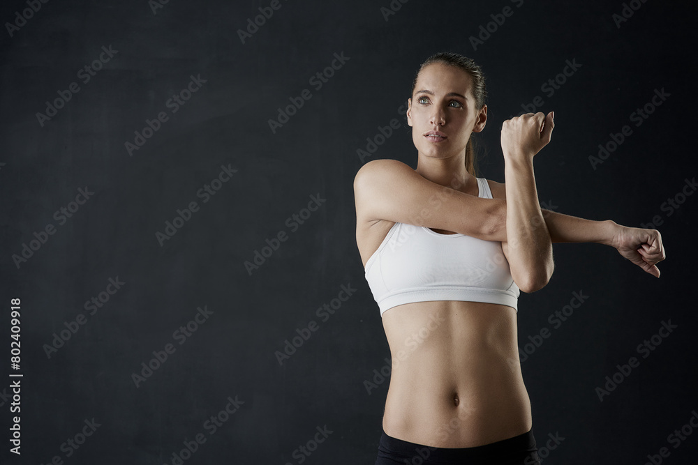 Obraz premium Woman, stretch and arms for fitness in studio for health training or workout as athlete runner for marathon competition. Active, female person and sports for strong muscle or achievement of goal