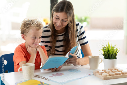 Mother and son enjoy reading a children's book at home