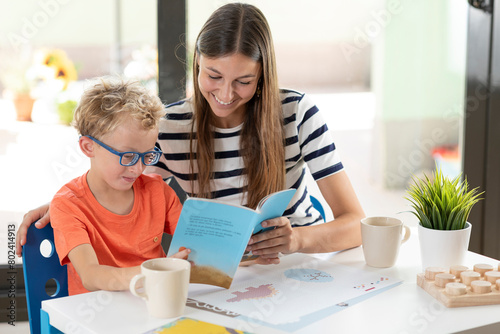 Mother and myopic son enjoy reading a children's book at home