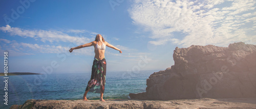 Happy teenage girl standing and enjoying on the beach