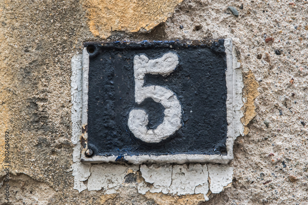 Old retro weathered cast iron plate with number 5 Old retro weathered cast iron plate with number 5