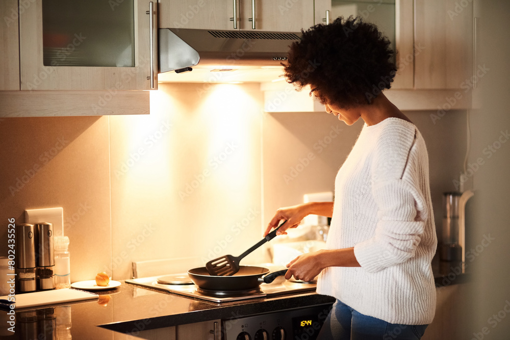 © peopleimages.com - Black woman, pan and cooking on stove in home, frying and meal preparation in kitchen. Female person, apartment and nutrition in food, diet and wellness for cuisine on gas for dinner routine in house