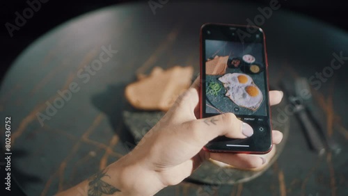 Food Vlogger taking a photo of her food