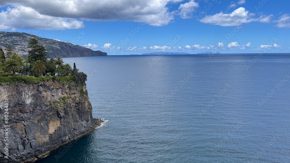 Fototapeta premium A stunning ocean view from a cliffside on Madeira Island, with clear blue skies and calm waters