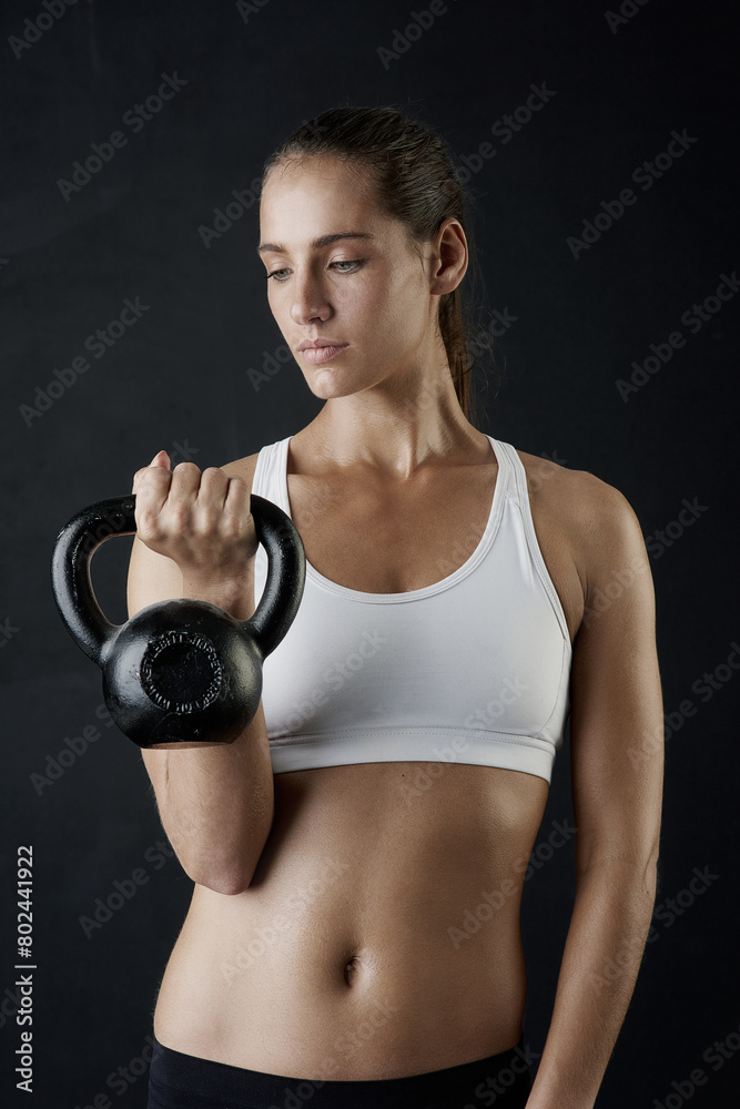 Woman, fitness and sport with kettle bell for weight lifting, strength training and exercise isolated in studio. Female person or bodybuilder and equipment for endurance workout, health and wellness Woman, fitness and sport with kettle bell for weight lifting, strength training and exercise isolated in studio. Female person or bodybuilder and equipment for endurance workout, health and wellness